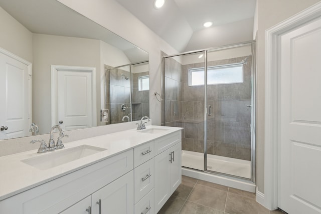 full bath featuring tile patterned flooring, double vanity, a stall shower, and a sink