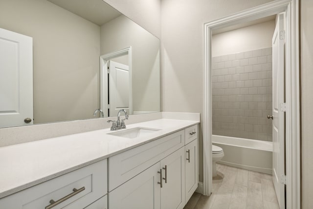 bathroom featuring vanity, toilet, wood finished floors, and shower / washtub combination