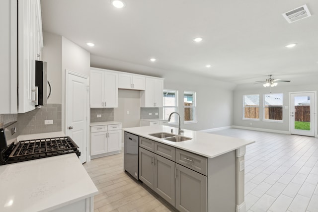 kitchen with visible vents, gray cabinets, a sink, stainless steel appliances, and light countertops