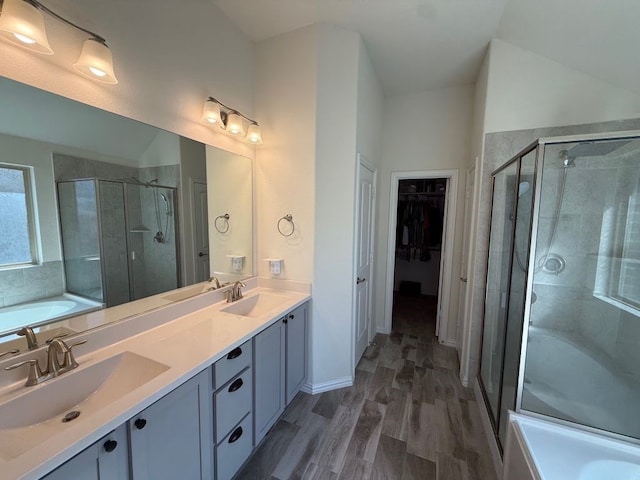 full bath with a shower stall, a garden tub, and a sink