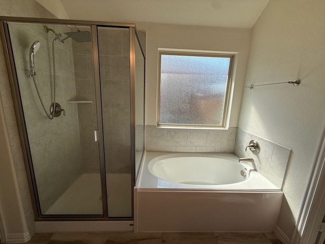 full bath with a garden tub and a shower stall