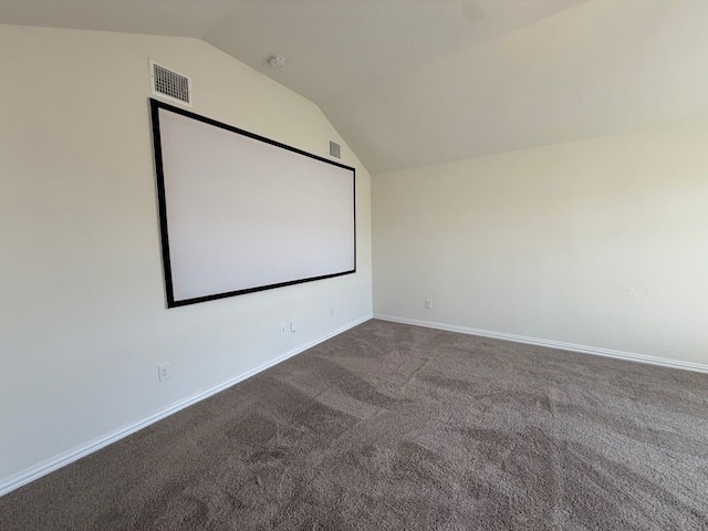 cinema room featuring visible vents, baseboards, carpet flooring, and vaulted ceiling