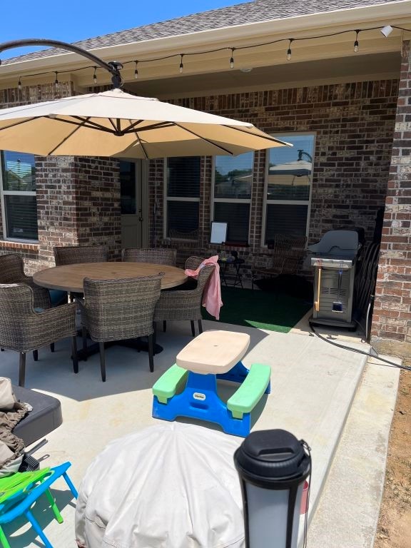 view of patio / terrace with a grill and outdoor dining area