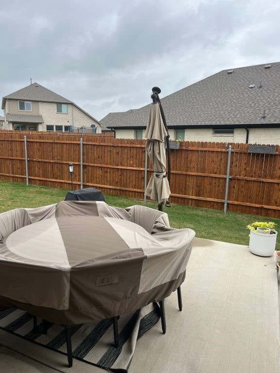 view of patio featuring fence