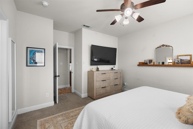 bedroom with visible vents, carpet floors, baseboards, and a ceiling fan