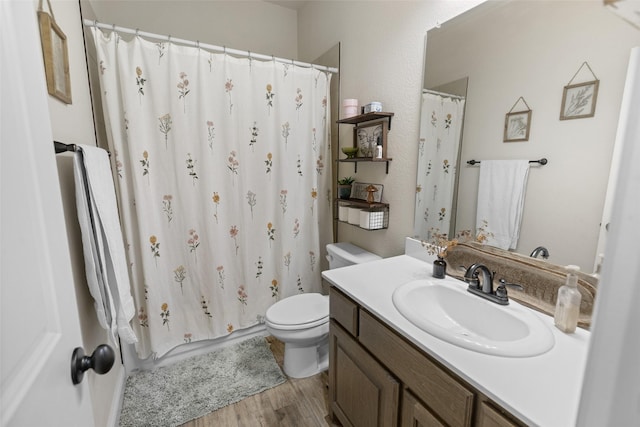 full bath featuring curtained shower, toilet, vanity, and wood finished floors