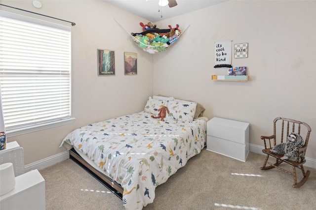 bedroom featuring multiple windows, carpet, and baseboards