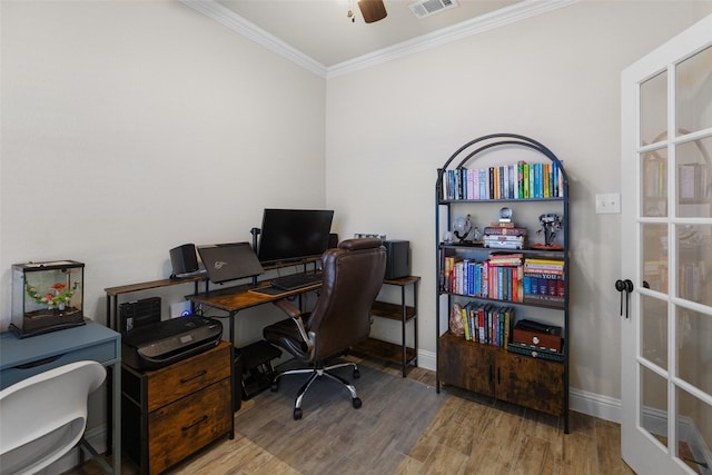 office space featuring visible vents, ornamental molding, wood finished floors, baseboards, and ceiling fan