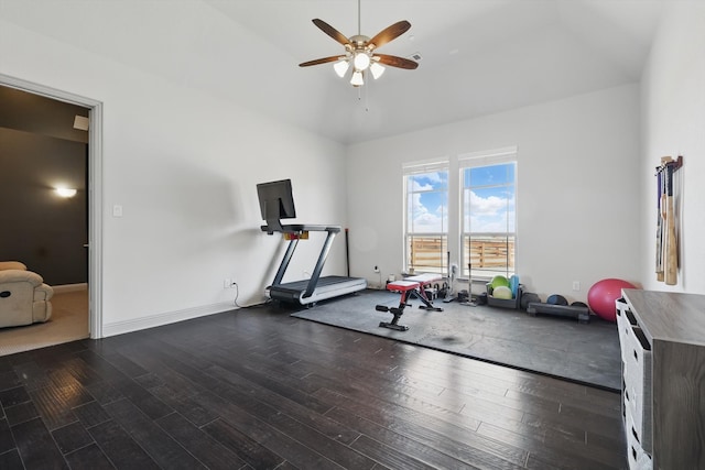 exercise area with a ceiling fan, wood finished floors, and baseboards