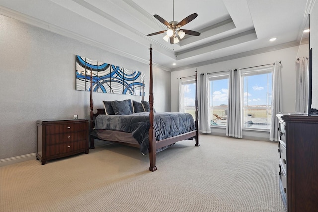 bedroom featuring a ceiling fan, baseboards, ornamental molding, light carpet, and a raised ceiling