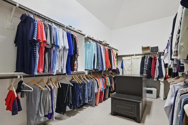 spacious closet with carpet floors and vaulted ceiling