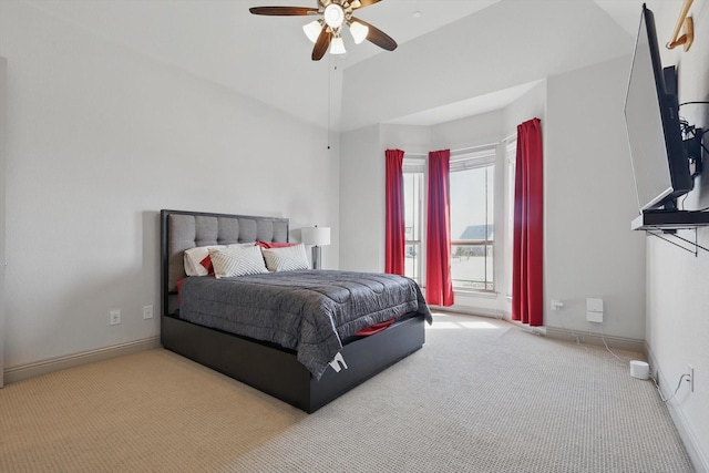 carpeted bedroom featuring baseboards, ceiling fan, and vaulted ceiling