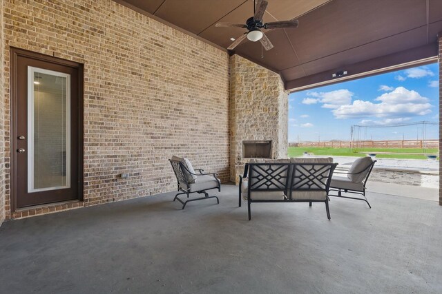 view of patio featuring outdoor lounge area, a ceiling fan, and fence