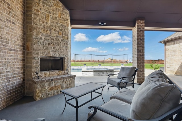 view of patio / terrace featuring an outdoor stone fireplace