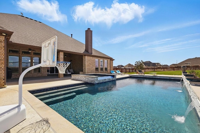 view of pool featuring a pool with connected hot tub, a ceiling fan, a patio, and fence