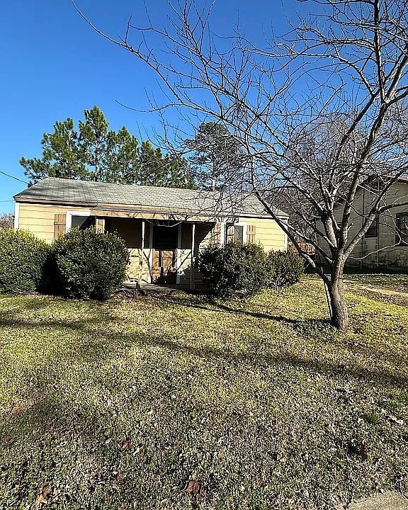 view of side of home with a lawn