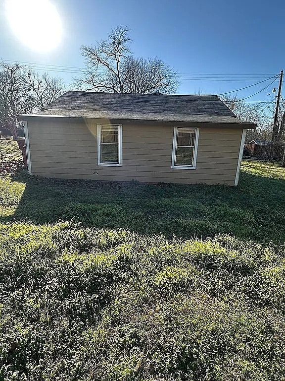 view of property exterior with a lawn