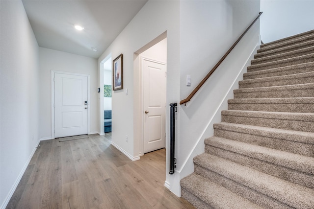 foyer entrance featuring stairs, light wood-style flooring, recessed lighting, and baseboards