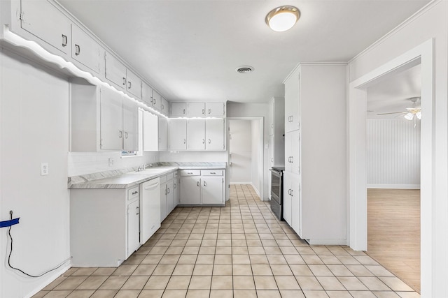 kitchen featuring visible vents, white dishwasher, light countertops, white cabinets, and electric stove