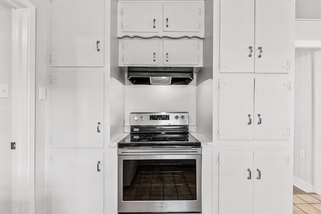 kitchen featuring under cabinet range hood, electric range, white cabinetry, and light countertops