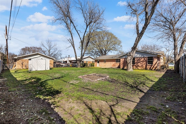 view of yard featuring an outbuilding, a storage unit, and a fenced backyard