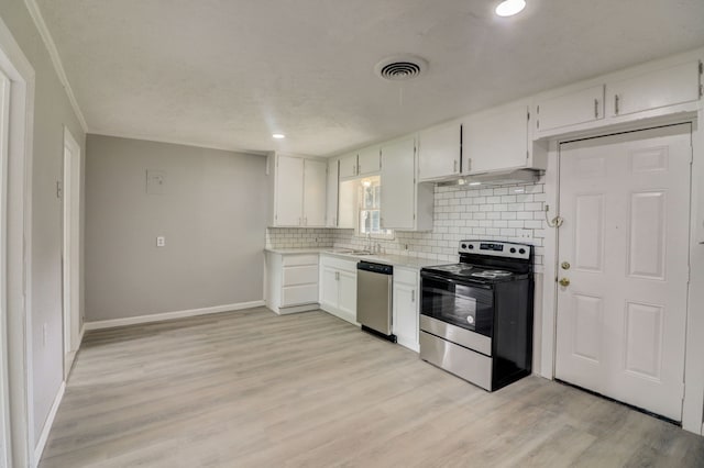 kitchen with visible vents, electric range, decorative backsplash, light countertops, and stainless steel dishwasher