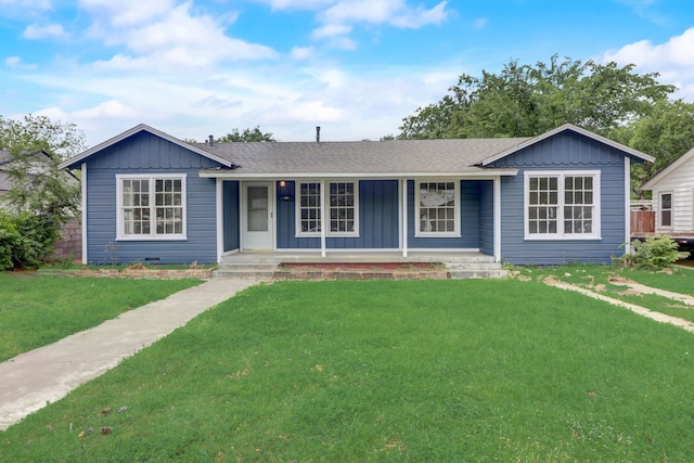 ranch-style home with roof with shingles, board and batten siding, covered porch, and a front yard