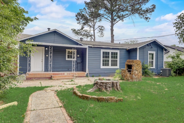 ranch-style house featuring a front lawn, central air condition unit, a porch, and a shingled roof