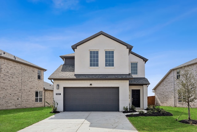 traditional-style home featuring roof with shingles, concrete driveway, a front yard, a garage, and brick siding