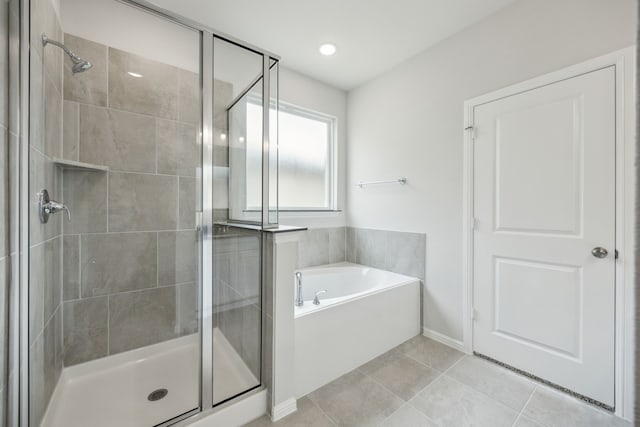 full bathroom featuring a bath and a stall shower