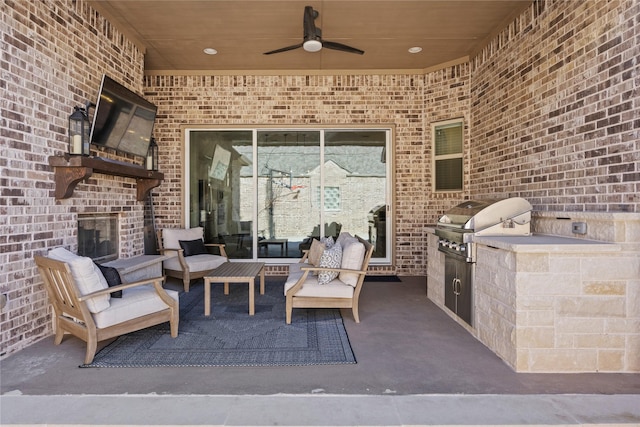 view of patio featuring area for grilling, an outdoor living space, a grill, and ceiling fan