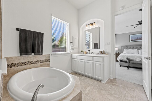 full bath with ceiling fan, vanity, ensuite bathroom, and a garden tub