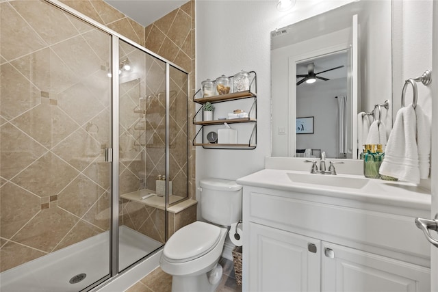 bathroom with toilet, a shower stall, and vanity