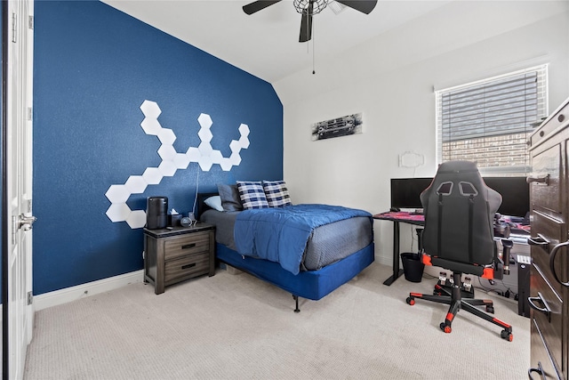 carpeted bedroom featuring vaulted ceiling, a ceiling fan, and baseboards