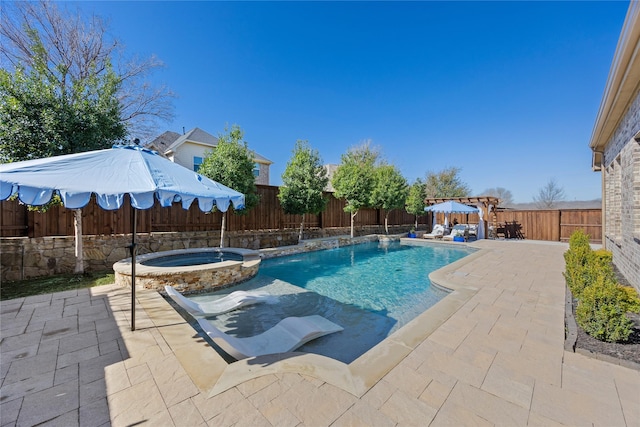 view of pool featuring a patio area, a pool with connected hot tub, and a fenced backyard