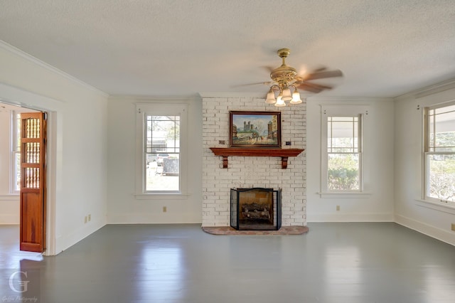 unfurnished living room featuring a brick fireplace, a textured ceiling, and crown molding