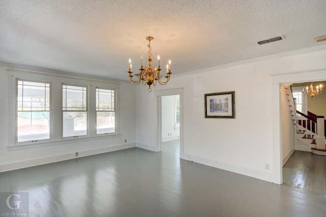 empty room with a wealth of natural light, a notable chandelier, stairway, and visible vents