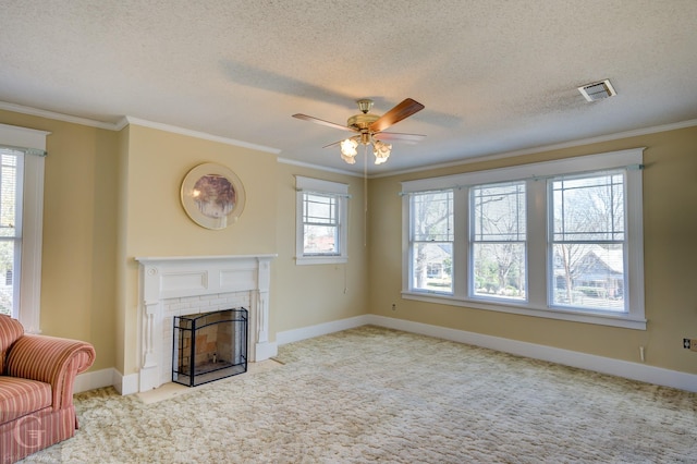 unfurnished living room featuring visible vents, a brick fireplace, crown molding, carpet floors, and a textured ceiling