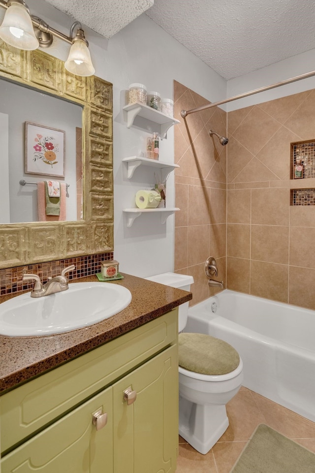 bathroom with tile patterned floors, toilet, shower / tub combination, and a textured ceiling