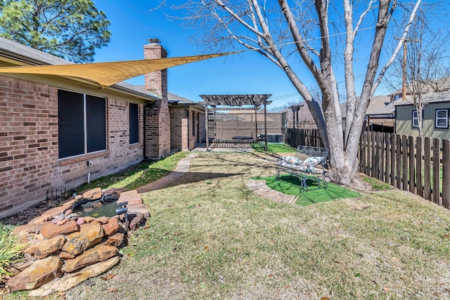 view of yard featuring a pergola and fence