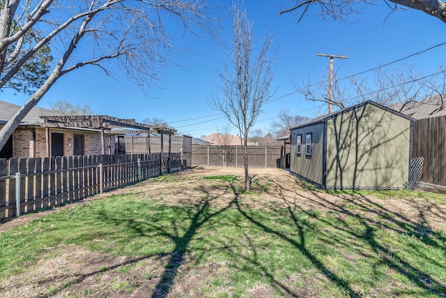 view of yard with an outbuilding, a fenced backyard, and a pergola