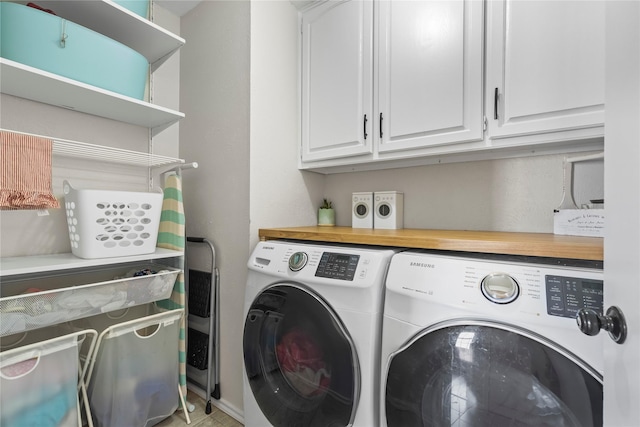 laundry area with washer and clothes dryer and cabinet space