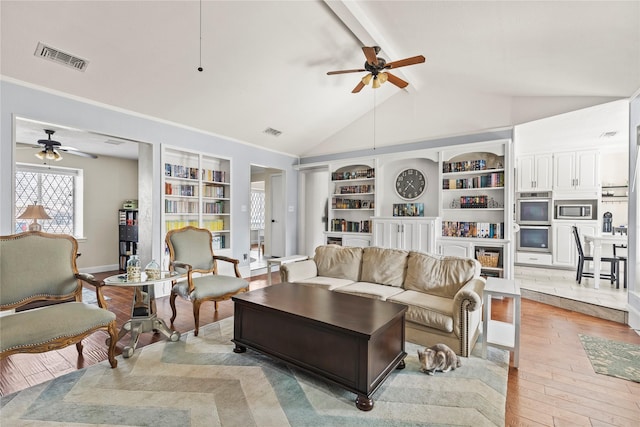 living area with lofted ceiling with beams, visible vents, a ceiling fan, and light wood finished floors