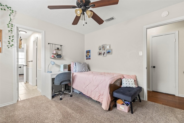 bedroom featuring visible vents, a ceiling fan, and carpet flooring