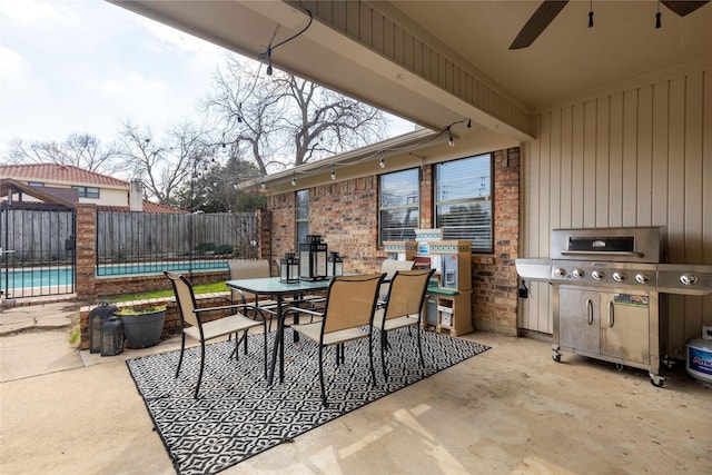 view of patio / terrace with a pool, fence, a ceiling fan, area for grilling, and outdoor dining area