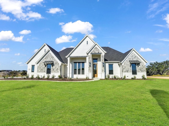 view of front facade featuring stone siding, a shingled roof, and a front lawn