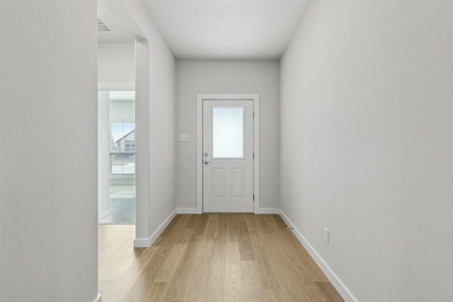 entryway featuring baseboards and light wood-type flooring