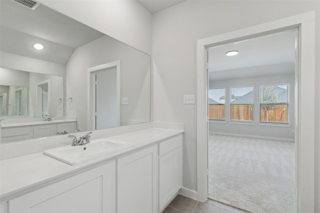 bathroom with visible vents, baseboards, recessed lighting, tile patterned floors, and vanity