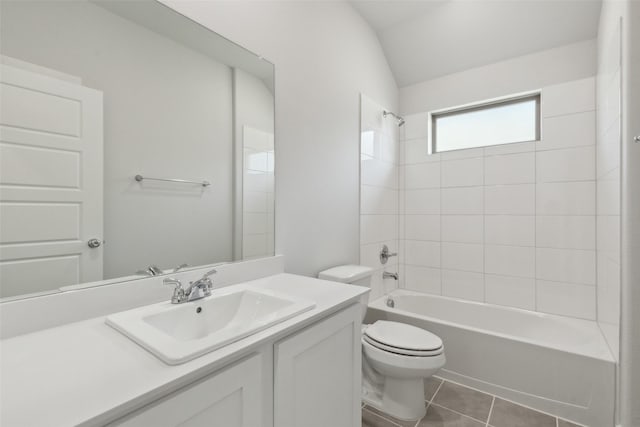 full bathroom featuring tile patterned floors, toilet, bathing tub / shower combination, vanity, and vaulted ceiling