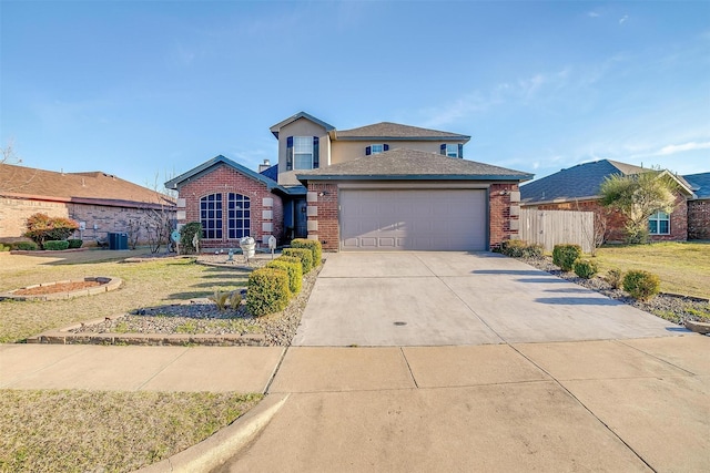 traditional-style home featuring concrete driveway, a garage, brick siding, and a front yard